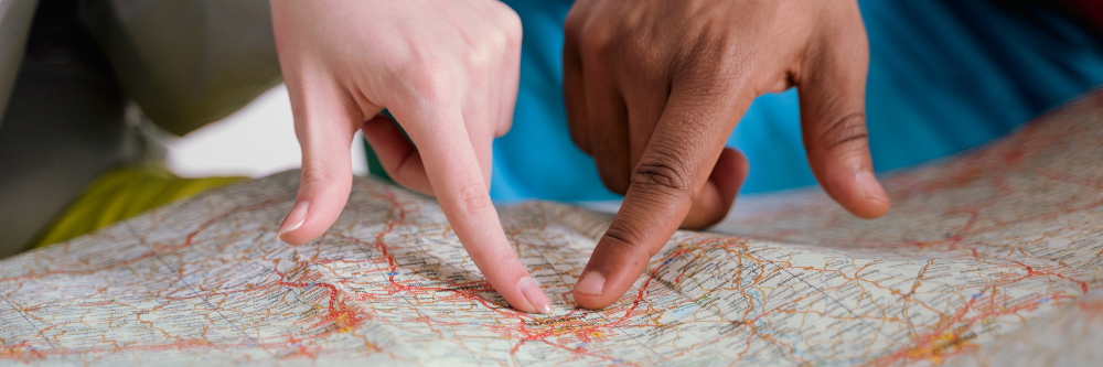 fingers pointing on map