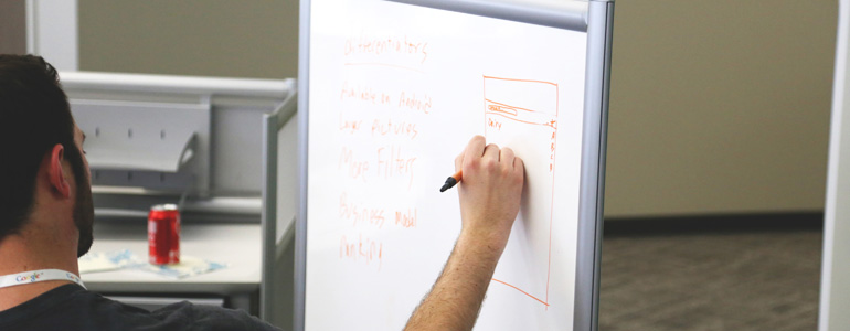 Man Drawing On A Whiteboard