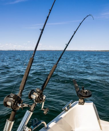 Angler casting a line in serene lake