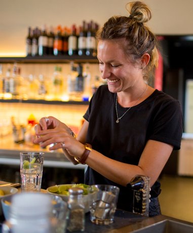 Bar worker serving drinks