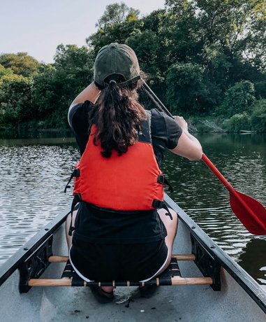 Canoeist navigating a river