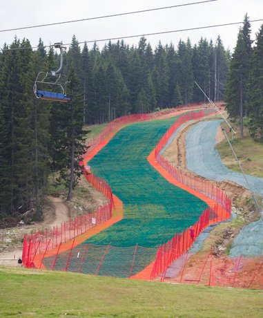 Snowboarder sliding down a dry slope
