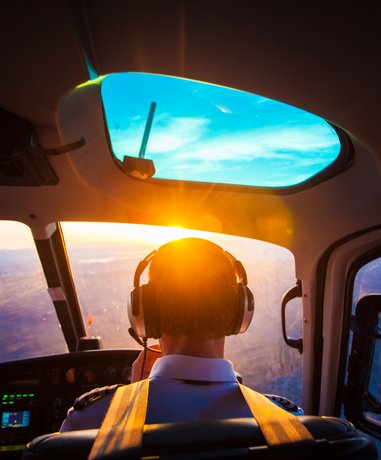 Pilot in cockpit managing controls