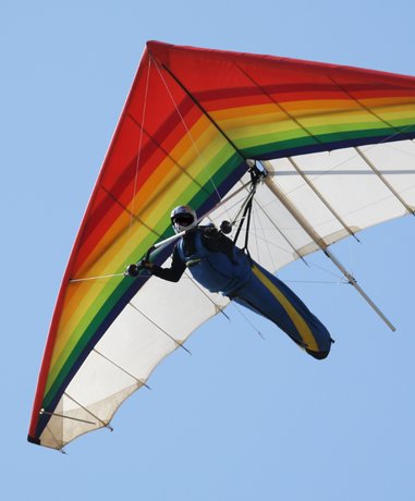 Hang glider soaring over mountains