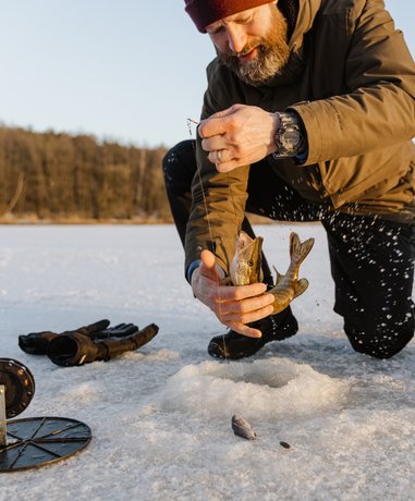 Ice fisherman on a frozen lake