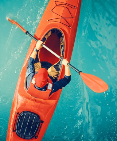 Kayaker paddling in the sea