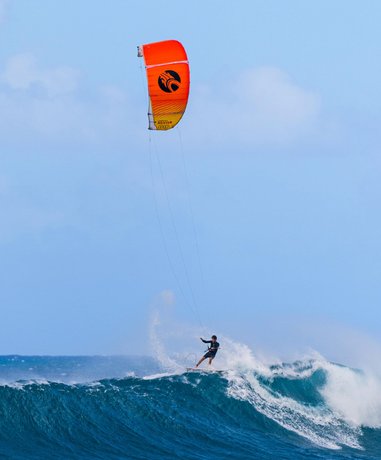 Kite surfer riding waves