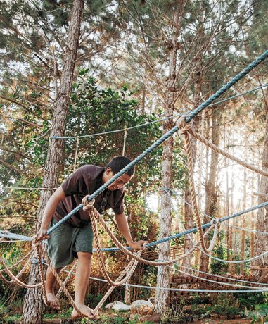 Participants engaging in a low ropes course