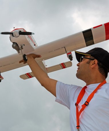 Model sports enthusiast operating a model airplane