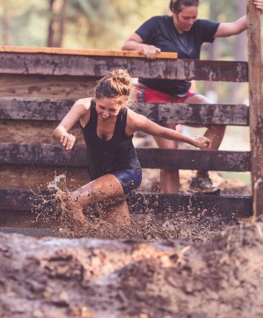 Tough Mudder participant overcoming an obstacle