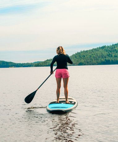 Paddle boarder on calm water