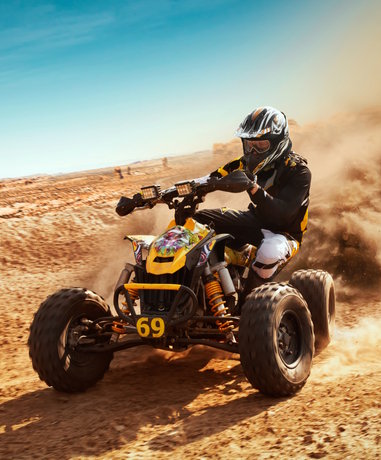 Quad biker in action on rough terrain