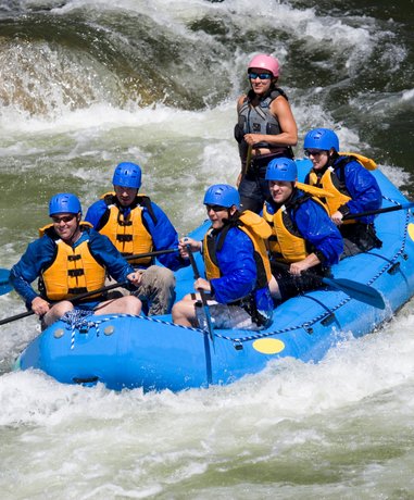 Rafters navigating rapid waters