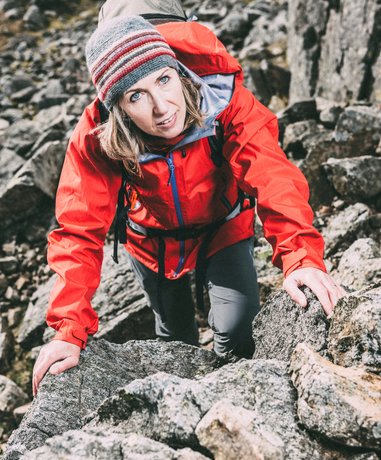 Rock scrambler climbing a rugged mountain