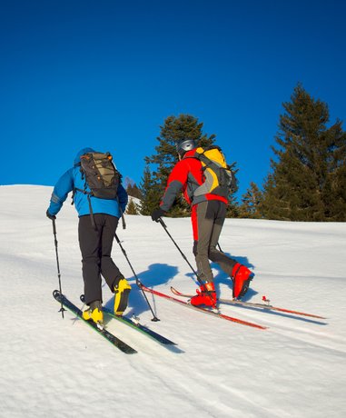 Skier ascending a snowy mountain slope