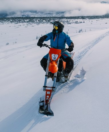 Snow biker riding on snowy trail