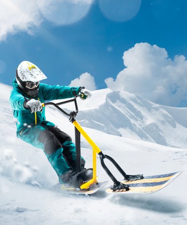 Snow scooting rider in action on snowy slope