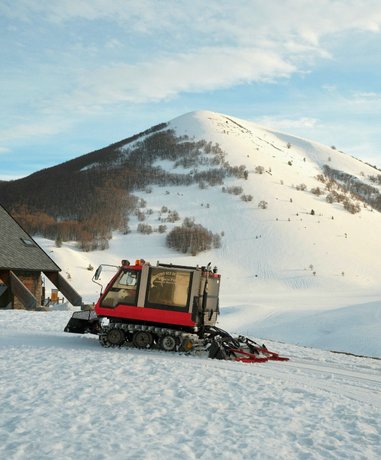 Snowcat in snowy mountains