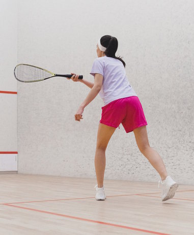 Squash player in action on court