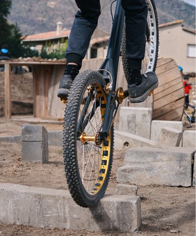 Trials rider performing on rocky terrain