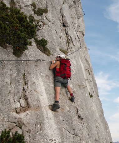 Climber ascending a Via Ferrata route