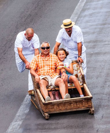 Participants enjoying a wicker basket toboggan ride